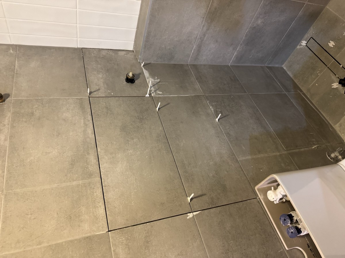 Floor tiles being laid with spacers