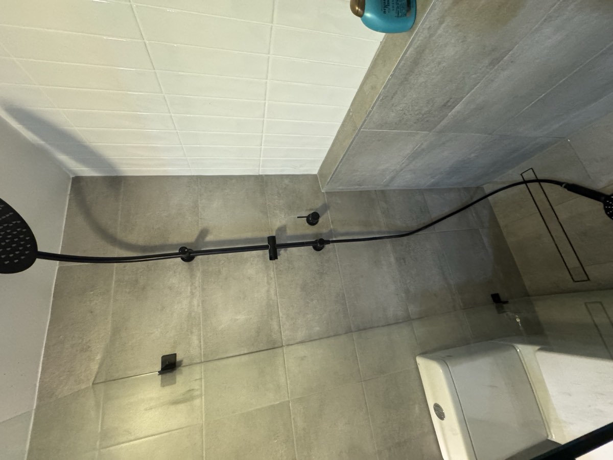 Finished tiled bathroom with black tapware